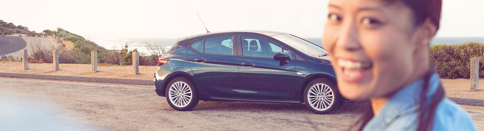 A Woman Standing in Front of a Holden Astra Hatch