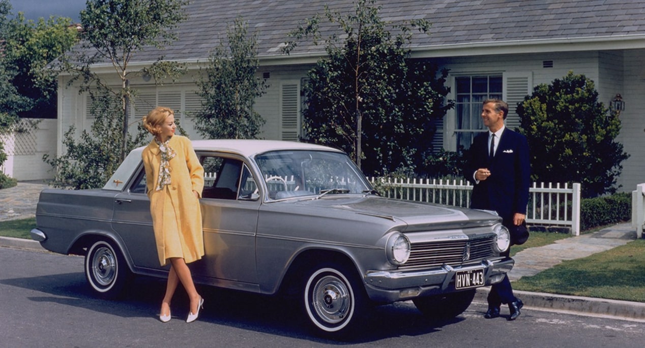 A Couple Standing by a Classic Holden