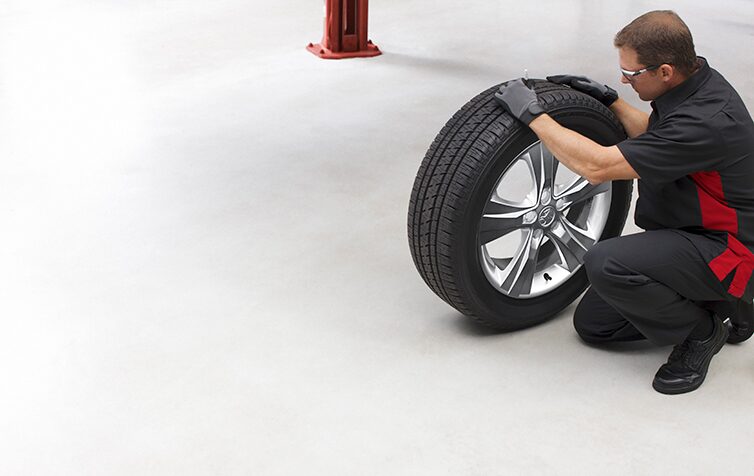 Holden Service Technician Handling a Tyre